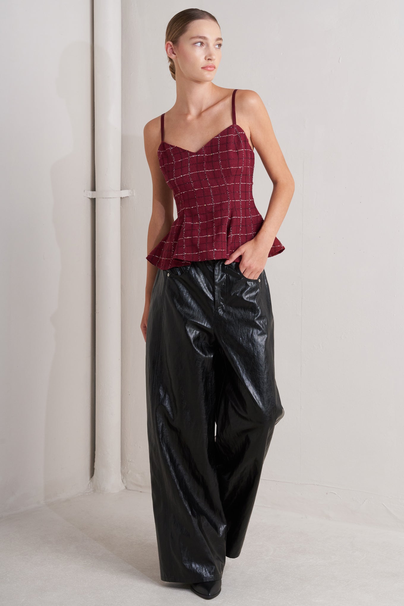 A tweed cami top featuring straps, peplum and back zipper closure