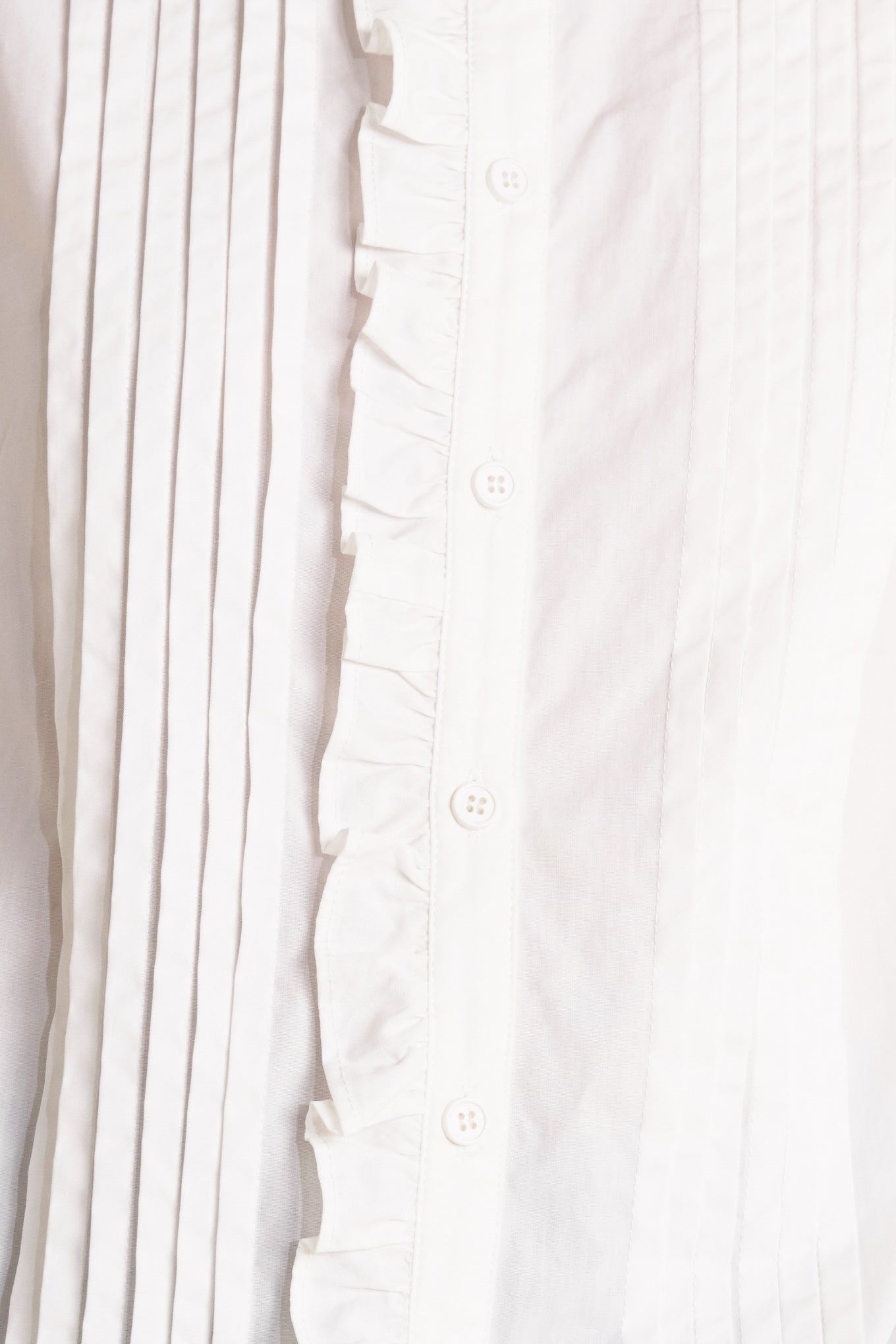 A solid woven top featuring ruffled high neckline, long sleeve and front button down closure