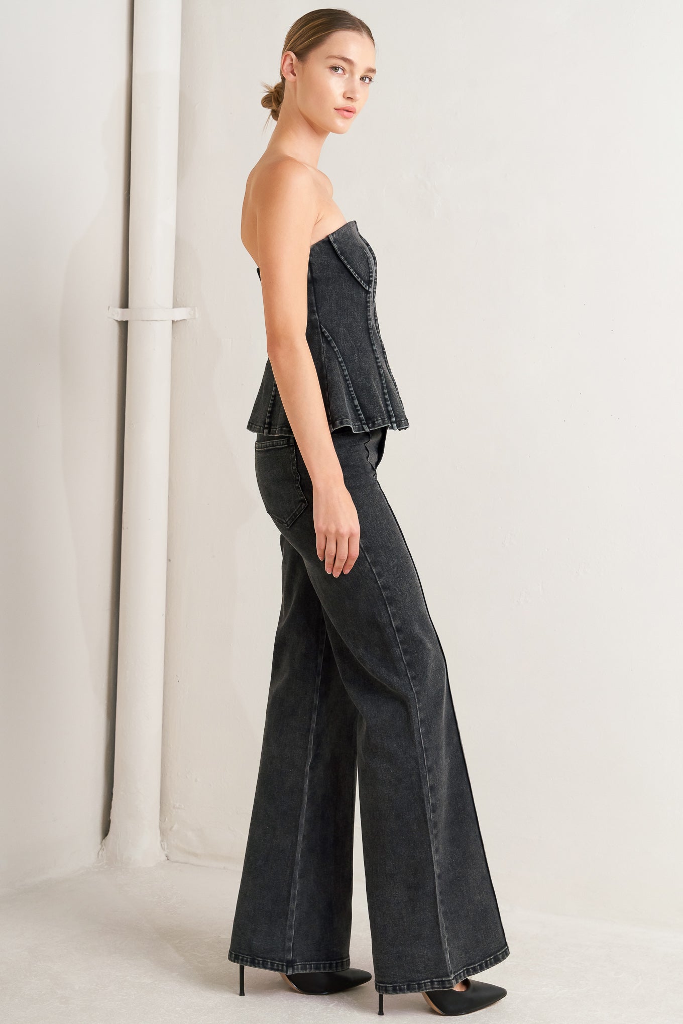 A washed denim top featuring strapless neckline and back zipper closure