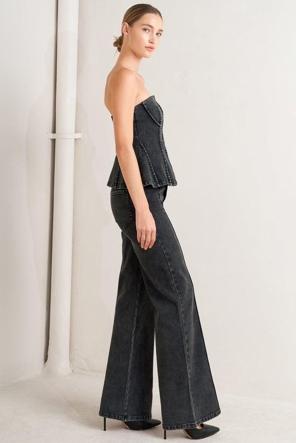 A washed denim top featuring strapless neckline and back zipper closure