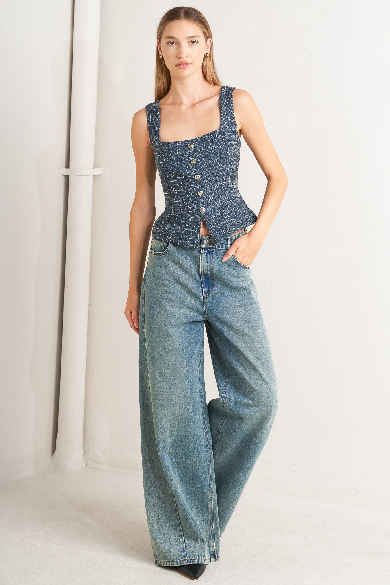 A tweed top featuring square neckline, sleeveless, button down detail and back zipper closure