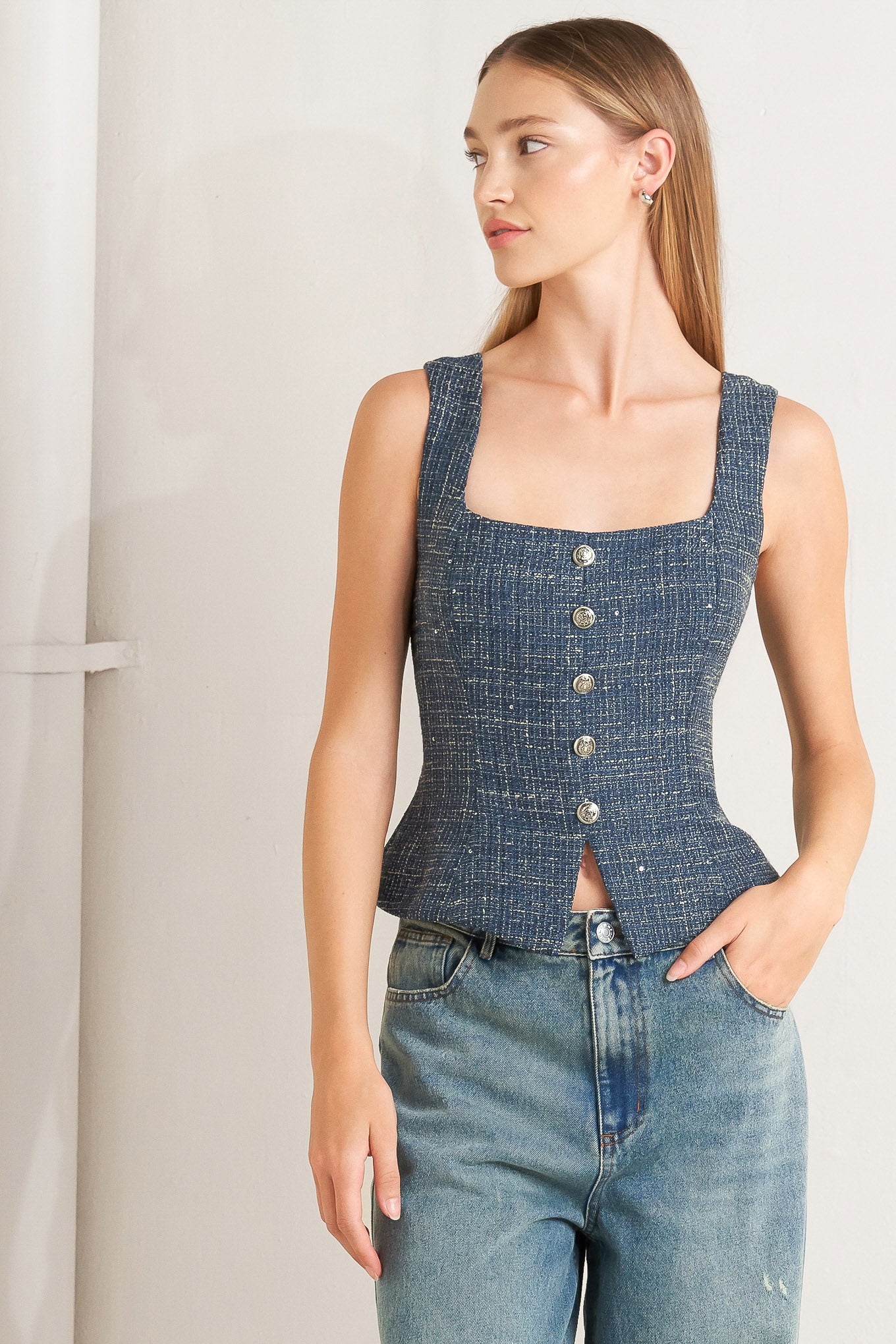 A tweed top featuring square neckline, sleeveless, button down detail and back zipper closure