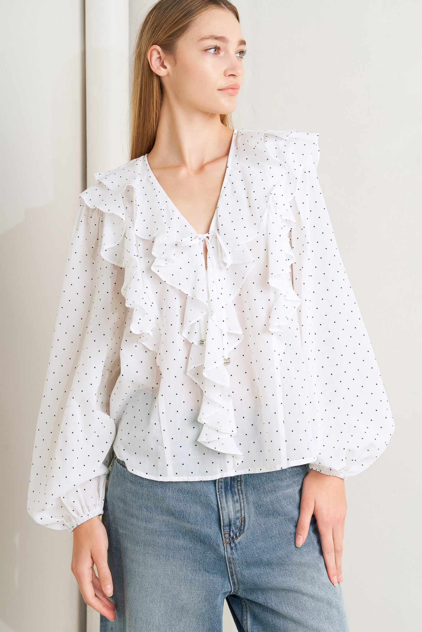 
A dotted woven top featuring V neckline, front tie, ruffles and long sleeve

Details:

Self : 100% Cotton

Size &amp; Fit

- Model is 5`8" And Wearing Size Small
- Measurements Taken From Size Small
- Approx. Length: 25" FLYING TOMATO