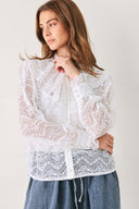 A woman wearing a white long-sleeve lace blouse with a ruffled collar | FREEMARKET