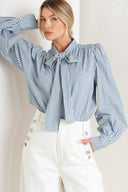 A striped woven top featuring bow tie front, button down and long sleeve with wide cuff

Details:

Self: 100% Cotton

Size & Fit

- Model is 5`8" And Wearing Size Small
- Measurements Taken From Size Small
- Approx. Length: 25"