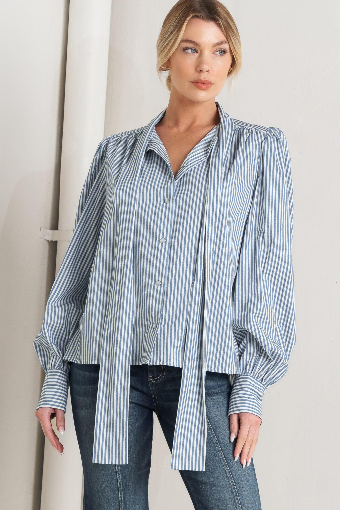 A striped woven top featuring bow tie front, button down and long sleeve with wide cuff

Details:

Self: 100% Cotton

Size & Fit

- Model is 5`8" And Wearing Size Small
- Measurements Taken From Size Small
- Approx. Length: 25"