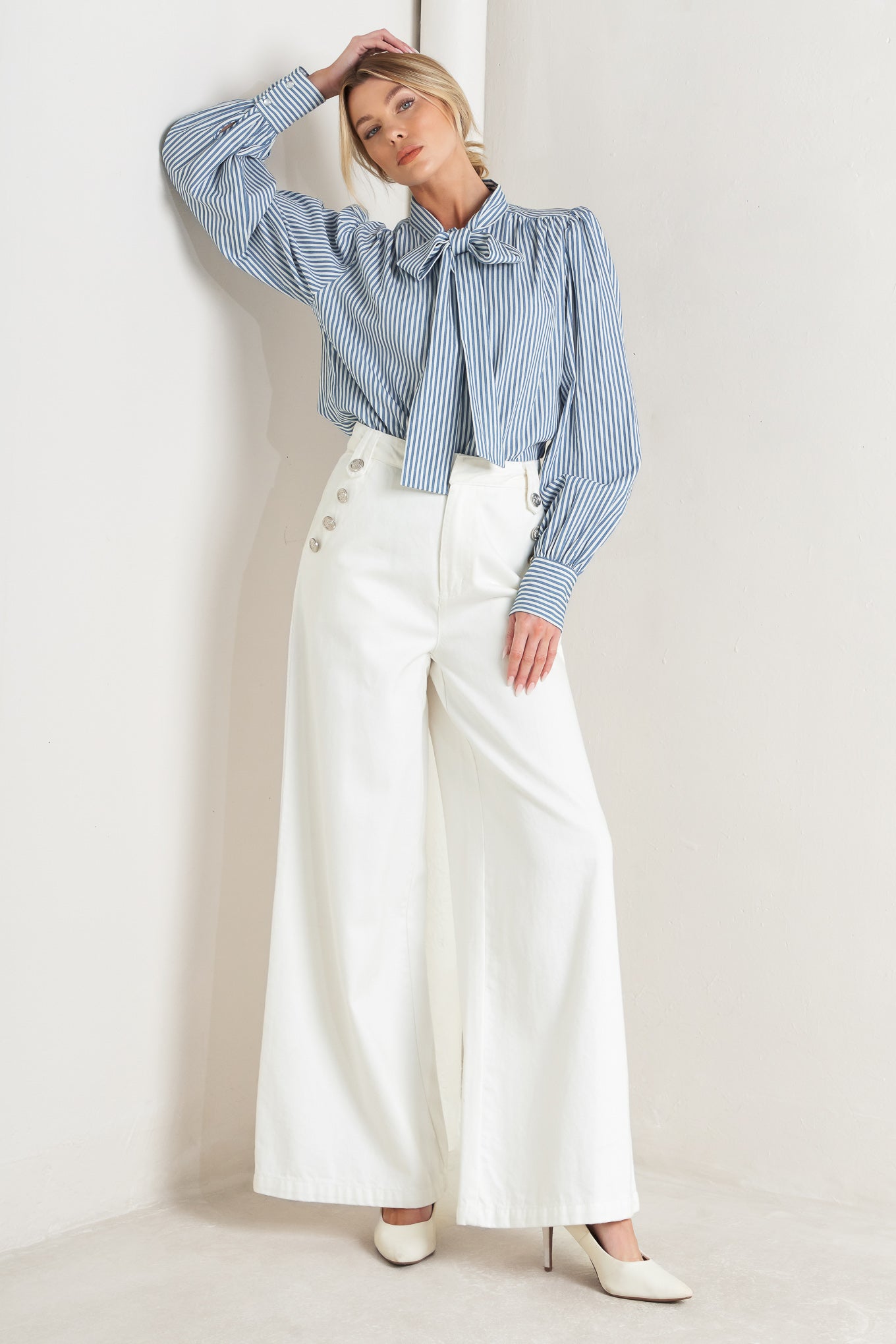 A striped woven top featuring bow tie front, button down and long sleeve with wide cuff

Details:

Self: 100% Cotton

Size & Fit

- Model is 5`8" And Wearing Size Small
- Measurements Taken From Size Small
- Approx. Length: 25"