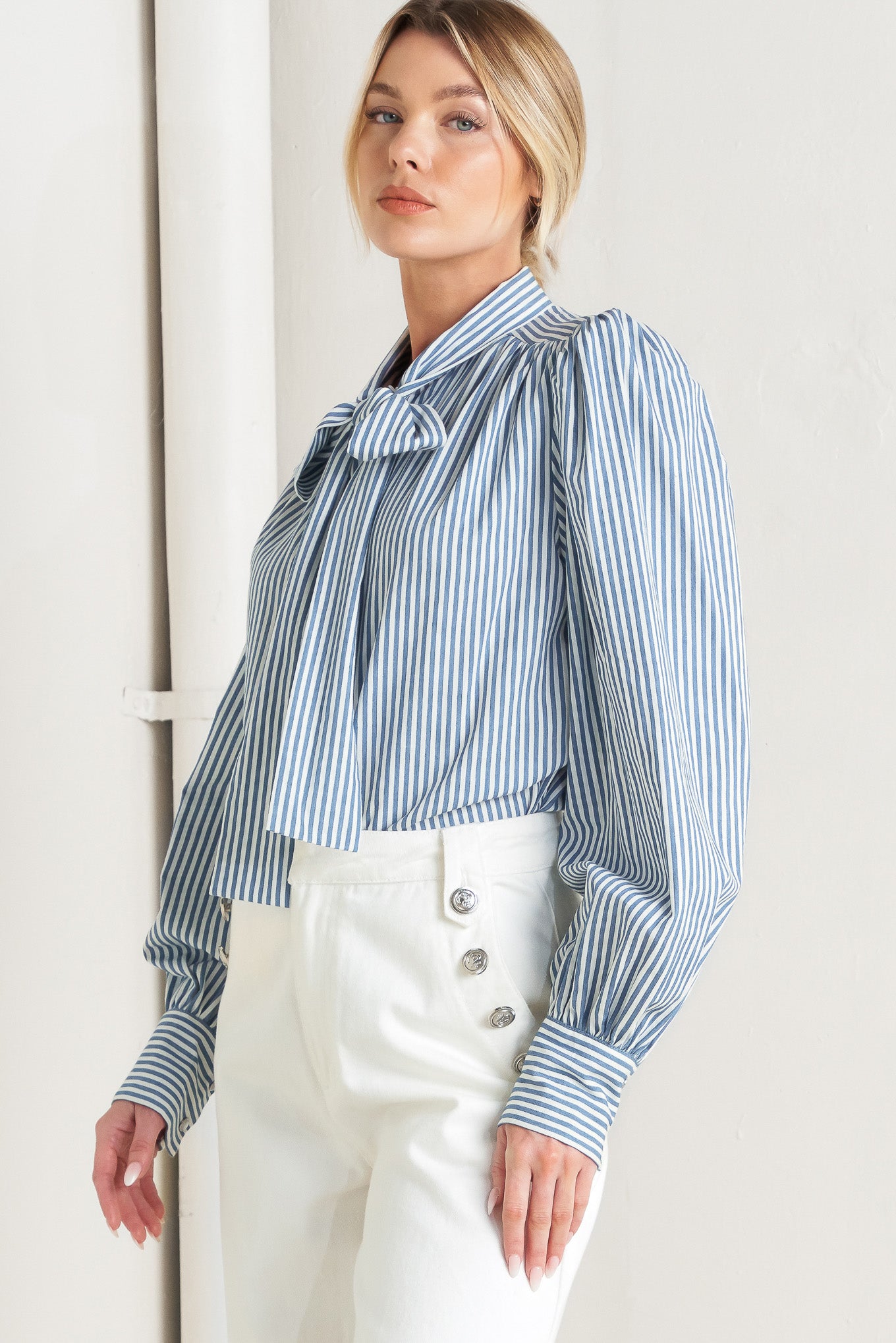 A striped woven top featuring bow tie front, button down and long sleeve with wide cuff

Details:

Self: 100% Cotton

Size & Fit

- Model is 5`8" And Wearing Size Small
- Measurements Taken From Size Small
- Approx. Length: 25"