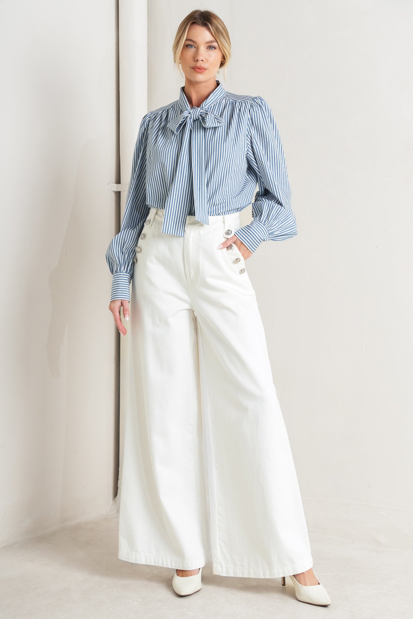 A striped woven top featuring bow tie front, button down and long sleeve with wide cuff

Details:

Self: 100% Cotton

Size & Fit

- Model is 5`8" And Wearing Size Small
- Measurements Taken From Size Small
- Approx. Length: 25"