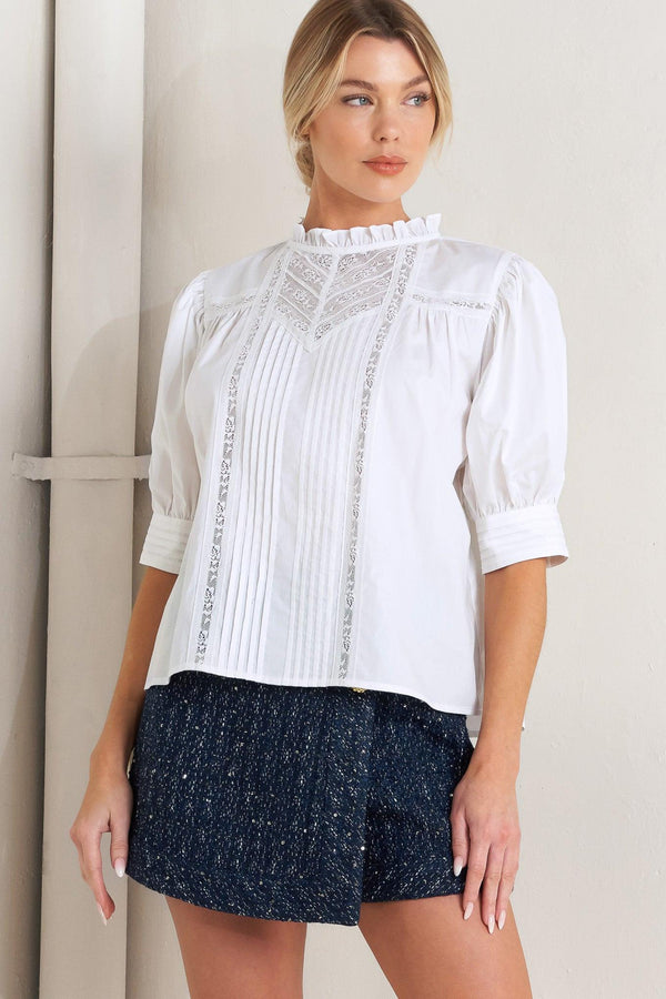 A solid woven top featuring ruffled high neck, pintuck and lace inset, short puff sleeve and back neck button closure

Details:

Self: 100% Cotton Exclusive of Decoration

Size & Fit

- Model is 5`8" And Wearing Size Small
- Measurements Taken From Size Small
- Approx. Length: 23"