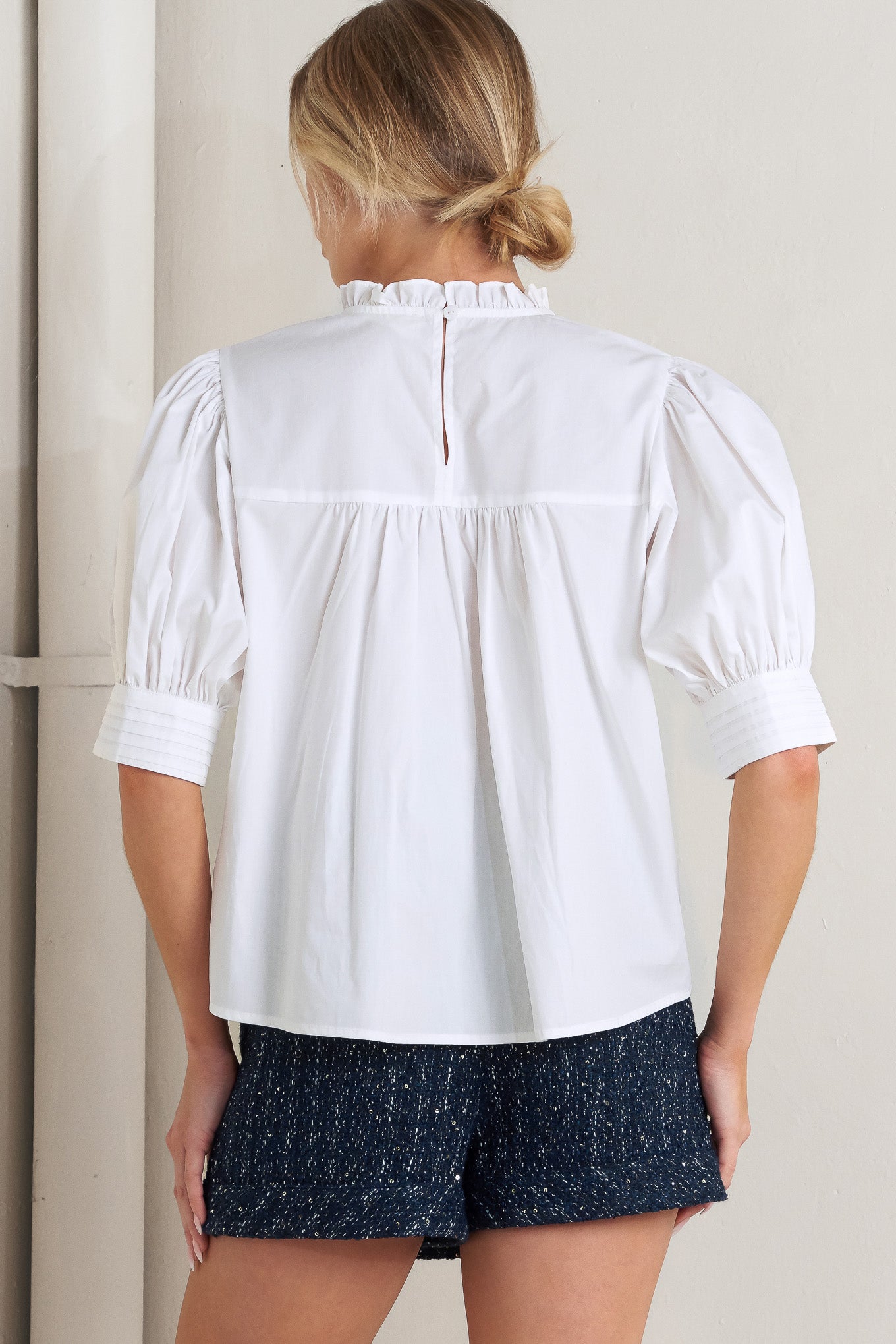 


A solid woven top featuring ruffled high neck, pintuck and lace inset, short puff sleeve and back neck button closure

Details:

Self : 100% Cotton Exclusive of Decoration

Size &amp; Fit

- Model is 5`8" And Wearing Size Small
- Measurements Taken From Size Small
- Approx. Length: 23"


