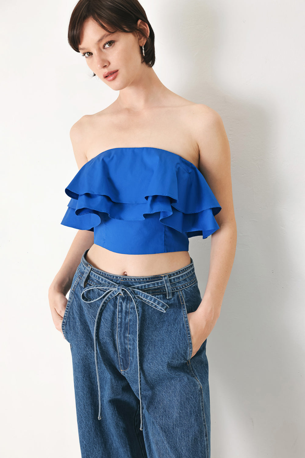 Woman wearing a blue ruffled top | FREEMARKET | Flying Tomato
