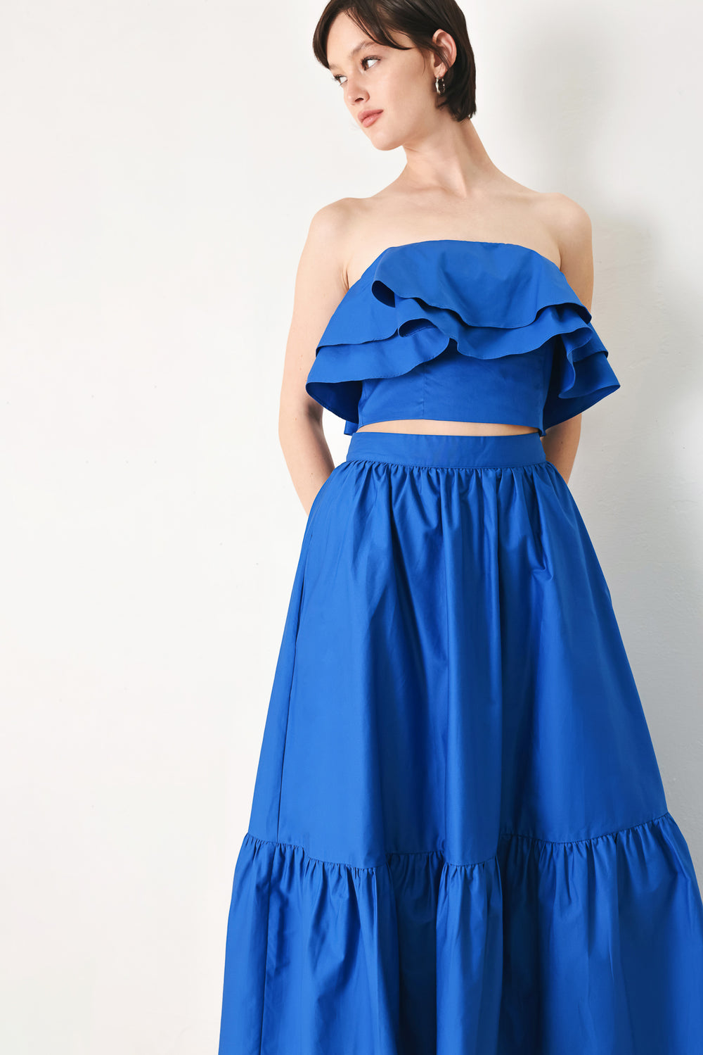 Woman wearing a blue ruffled top | FREEMARKET | Flying Tomato
