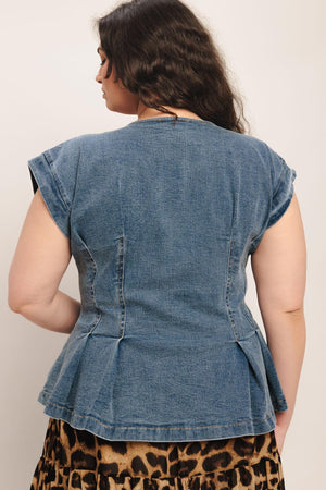 A washed denim top featuring V neckline, short sleeve, front button sown and peplum. Matching pant FP1946

Details:

Self: 99% Cotton 1% Spandex

Size &amp; Fit

Model is 5`8" And Wearing Size Small&nbsp;
Measurements Taken From Size Small&nbsp;
Approx. Length: 23"