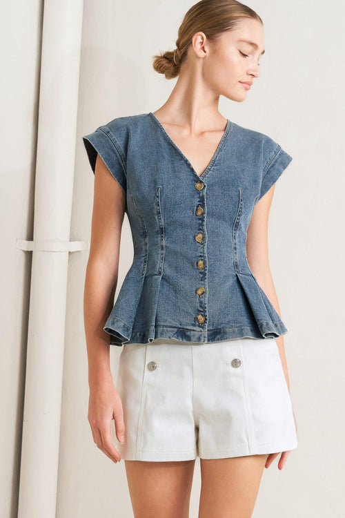 A washed denim top featuring V neckline, short sleeve, front button sown and peplum. Matching pant FP1946

Details:

Self: 99% Cotton 1% Spandex

Size & Fit

-Model is 5`8" And Wearing Size Small
-Measurements Taken From Size Small
-Approx. Length: 23"