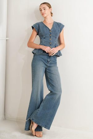 A washed denim top featuring V neckline, short sleeve, front button sown and peplum. Matching pant FP1946

Details:

Self: 99% Cotton 1% Spandex

Size & Fit

-Model is 5`8" And Wearing Size Small
-Measurements Taken From Size Small
-Approx. Length: 23"