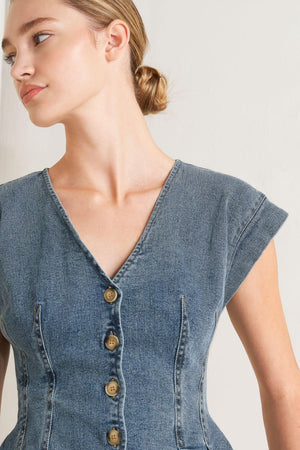 A washed denim top featuring V neckline, short sleeve, front button sown and peplum. Matching pant FP1946

Details:

Self: 99% Cotton 1% Spandex

Size & Fit

-Model is 5`8" And Wearing Size Small
-Measurements Taken From Size Small
-Approx. Length: 23"
