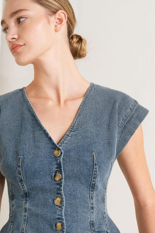 A washed denim top featuring V neckline, short sleeve, front button sown and peplum. Matching pant FP1946

Details:

Self: 99% Cotton 1% Spandex

Size & Fit

-Model is 5`8" And Wearing Size Small
-Measurements Taken From Size Small
-Approx. Length: 23"