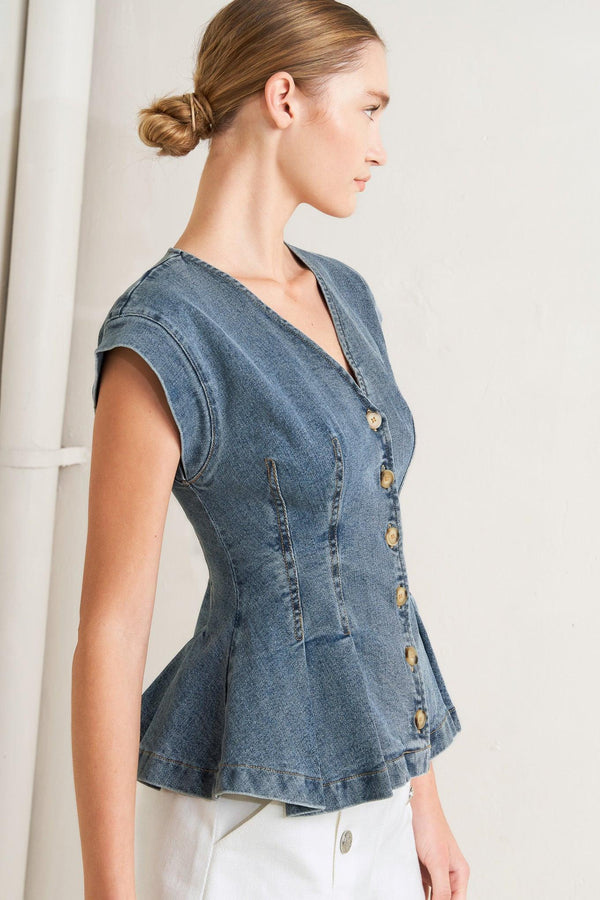 A washed denim top featuring V neckline, short sleeve, front button sown and peplum. Matching pant FP1946

Details:

Self: 99% Cotton 1% Spandex

Size & Fit

-Model is 5`8" And Wearing Size Small
-Measurements Taken From Size Small
-Approx. Length: 23"