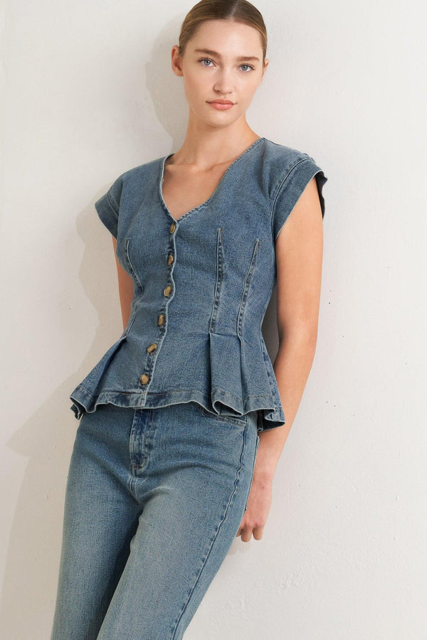 A washed denim top featuring V neckline, short sleeve, front button sown and peplum. Matching pant FP1946

Details:

Self: 99% Cotton 1% Spandex

Size & Fit

-Model is 5`8" And Wearing Size Small
-Measurements Taken From Size Small
-Approx. Length: 23"