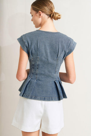 A washed denim top featuring V neckline, short sleeve, front button sown and peplum. Matching pant FP1946

Details:

Self: 99% Cotton 1% Spandex

Size & Fit

-Model is 5`8" And Wearing Size Small
-Measurements Taken From Size Small
-Approx. Length: 23"