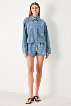 Woman wearing a blue bandana patterned denim jacket with front closure | FREEMARKET | Flying Tomato