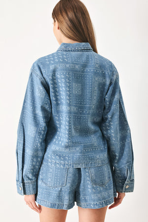Woman wearing a blue bandana patterned denim jacket with front closure | FREEMARKET | Flying Tomato