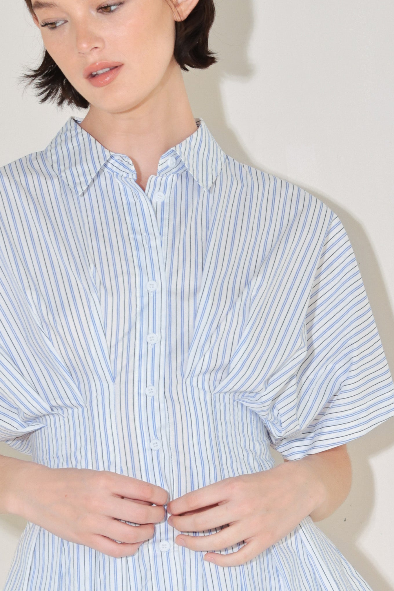 
A striped woven top featuring collar, short dolman sleeve, button down, corset waist and peplum

Details:

Self : 100% Cotton

Size & Fit

- Model is 5`8" And Wearing Size Small
- Measurements Taken From Size Small
- Approx. Length: 25"