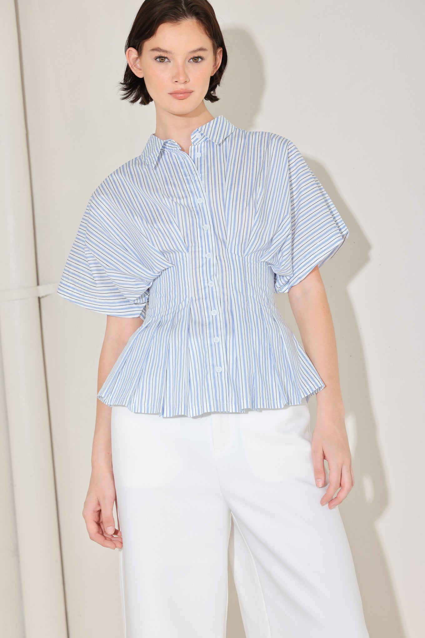 
A striped woven top featuring collar, short dolman sleeve, button down, corset waist and peplum

Details:

Self : 100% Cotton

Size & Fit

- Model is 5`8" And Wearing Size Small
- Measurements Taken From Size Small
- Approx. Length: 25"