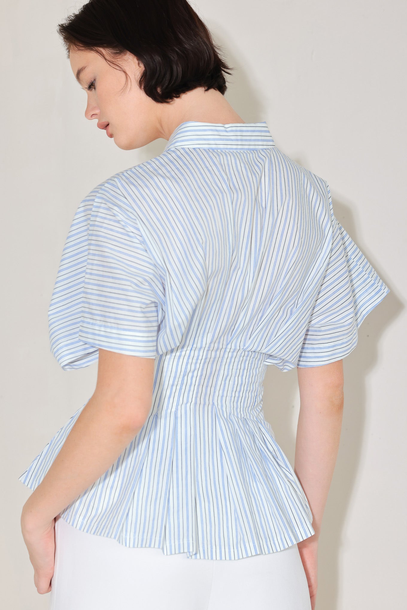 
A striped woven top featuring collar, short dolman sleeve, button down, corset waist and peplum

Details:

Self : 100% Cotton

Size & Fit

- Model is 5`8" And Wearing Size Small
- Measurements Taken From Size Small
- Approx. Length: 25"