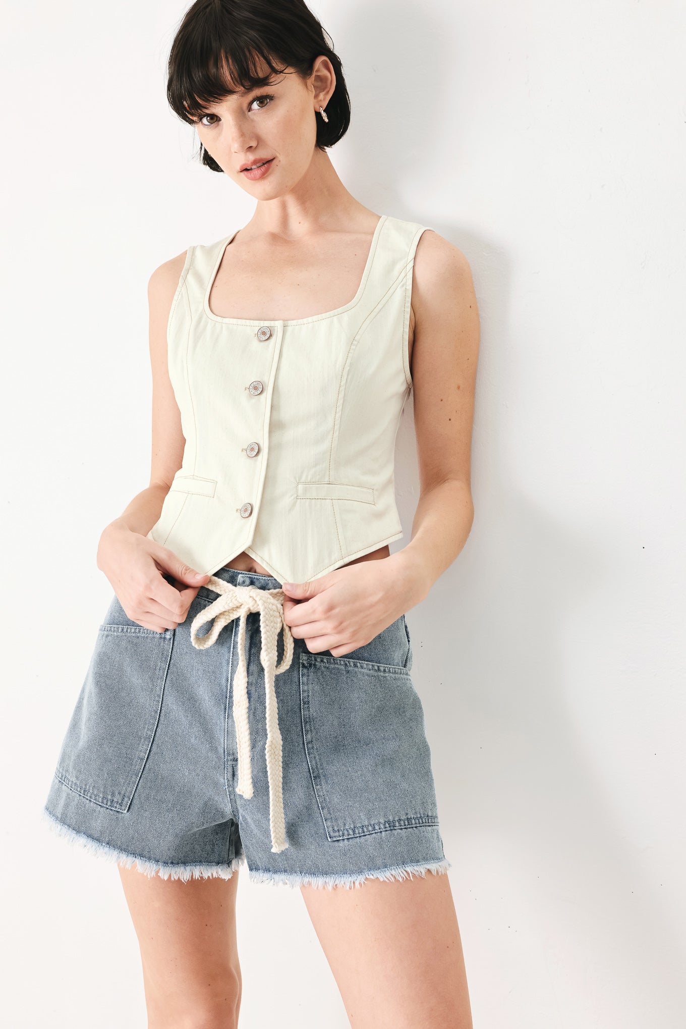 Woman wearing an oatmeal solid woven vest with U neckline, sleeveless and front button down | FREEMARKET