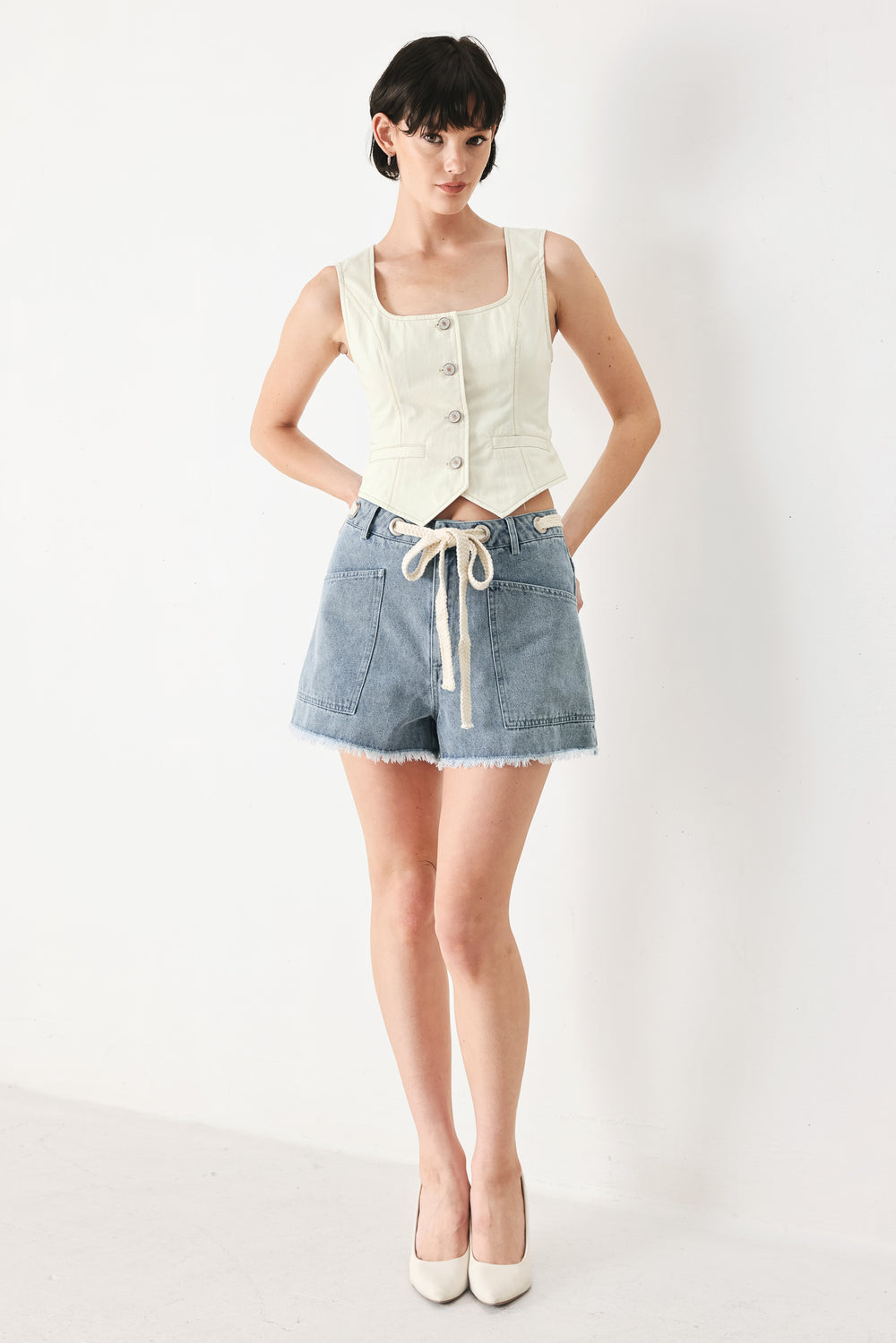 Woman wearing an oatmeal solid woven vest with U neckline, sleeveless and front button down | FREEMARKET