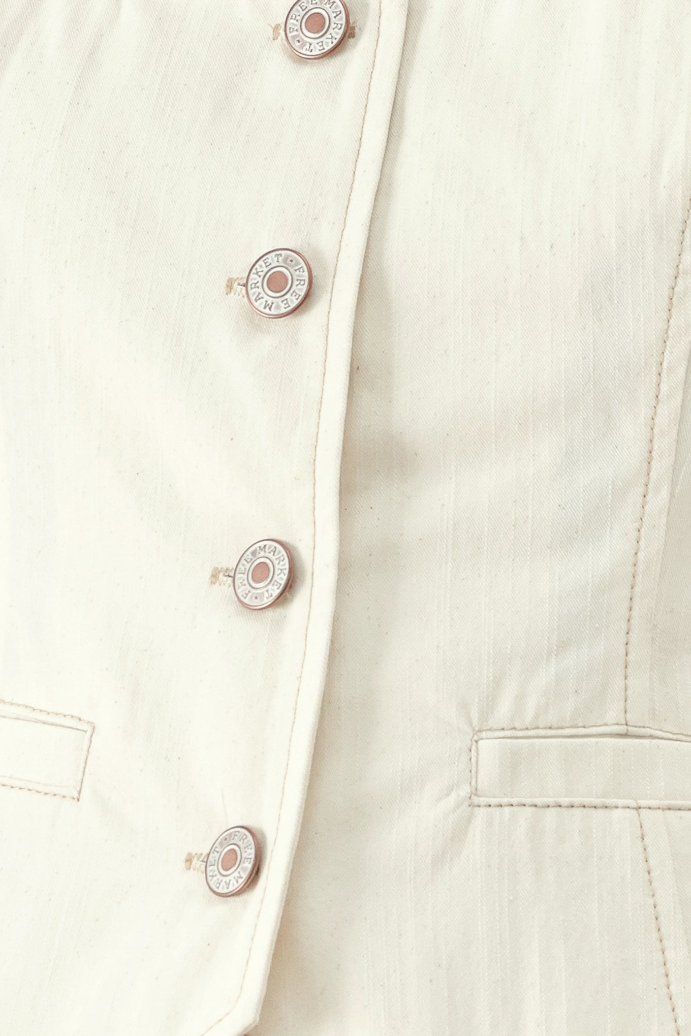 Close up of an oatmeal solid woven vest with U neckline, sleeveless and front button down | FREEMARKET