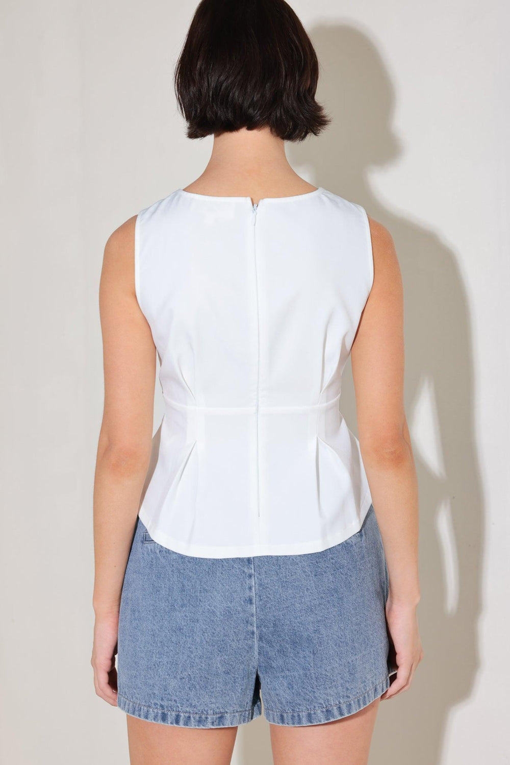 
A solid woven top featuring wide neckline, sleeveless, peplum with pleats and back zipper closure

Details:

Self : 96% Polyester 4% Spandex

Size &amp; Fit

- Model is 5`8" And Wearing Size Small
- Measurements Taken From Size Small
- Approx. Length: 22"
