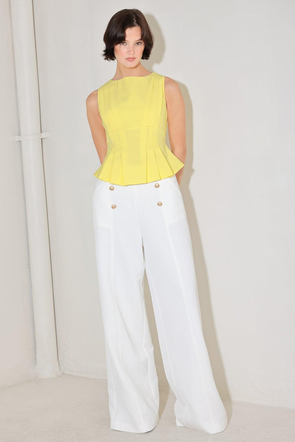 
A solid woven top featuring wide neckline, sleeveless, peplum with pleats and back zipper closure

Details:

Self : 96% Polyester 4% Spandex

Size &amp; Fit

- Model is 5`8" And Wearing Size Small
- Measurements Taken From Size Small
- Approx. Length: 22"