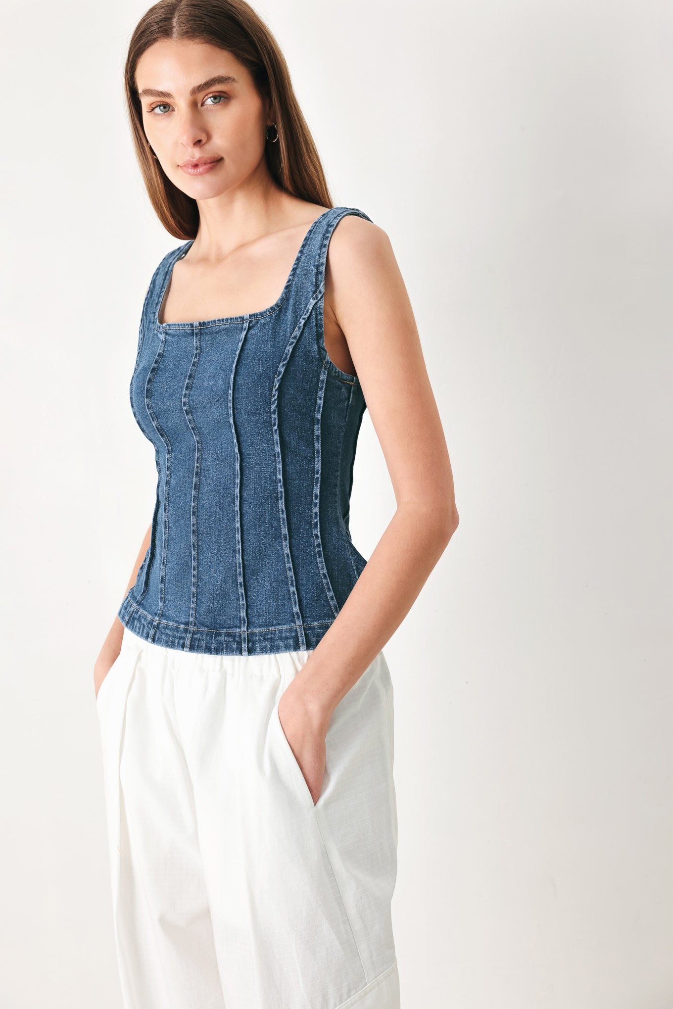 Woman wearing a sleeveless denim corset top with square neckline, peplum and back zipper closure | FREEMARKET | Flying Tomato