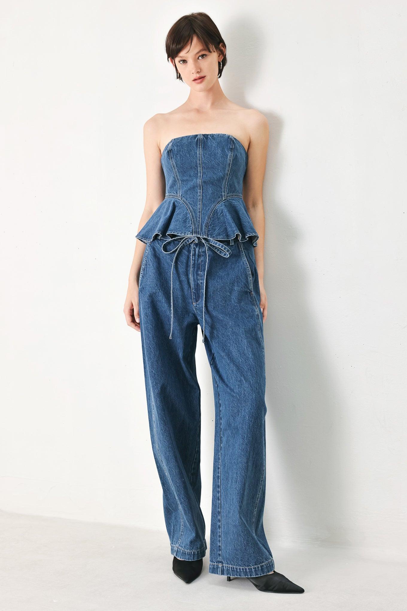 A washed denim top featuring strapless, ruffled peplum and back zipper closure
