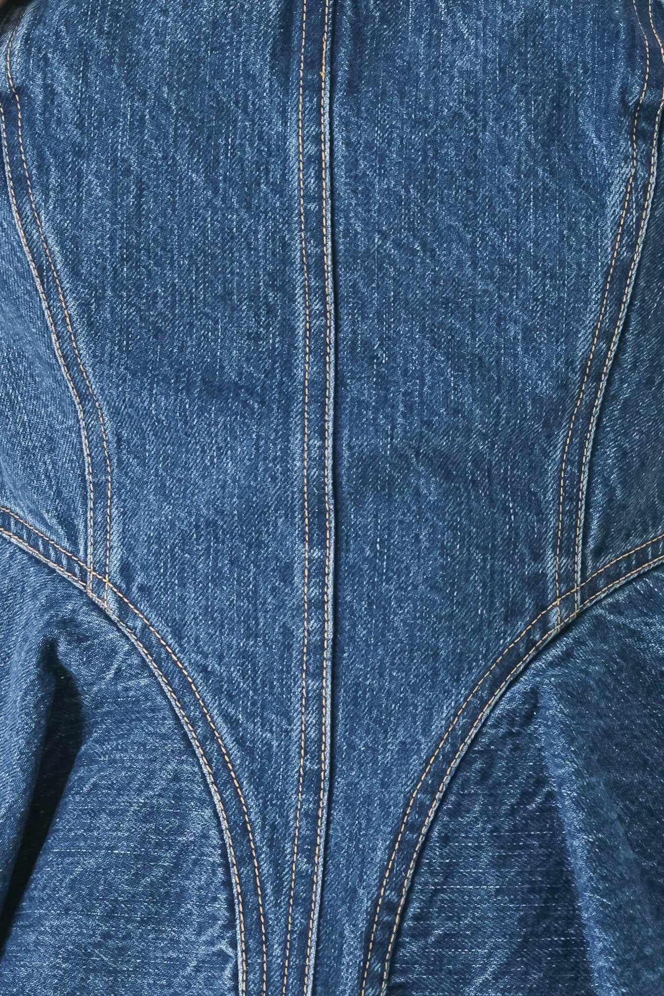 Close-up of blue denim fabric with stitching details