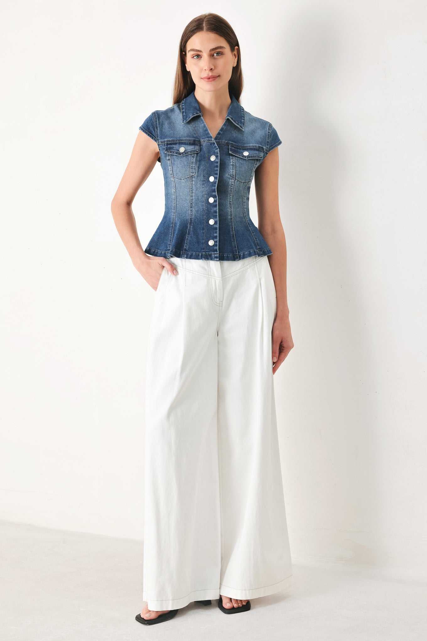 Woman wearing a denim top with collar, cap sleeve and front button down | FREEMARKET | Flying Tomato