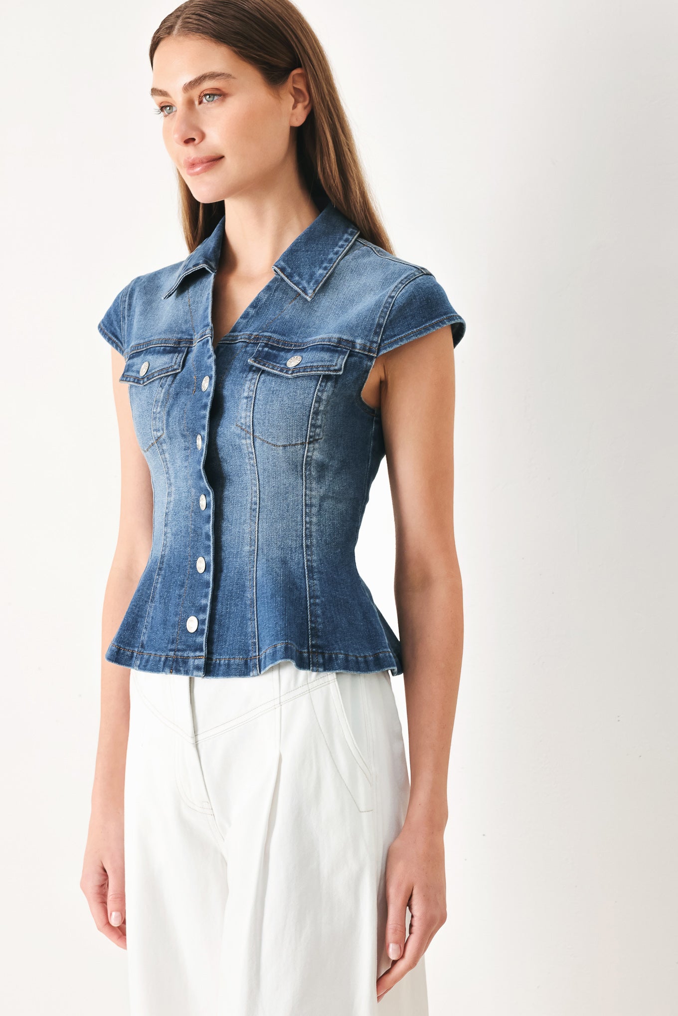 Woman wearing a denim top with collar, cap sleeve and front button down | FREEMARKET | Flying Tomato