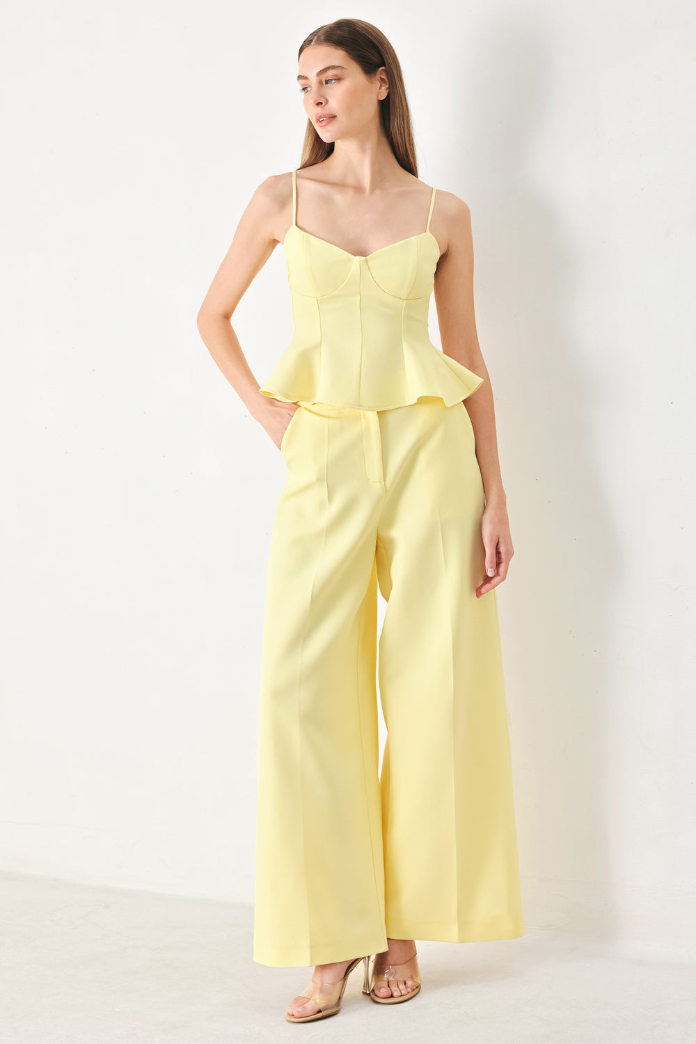 Woman wearing a yellow peplum cami top with back zipper closure | FREEMARKET | Flying Tomato