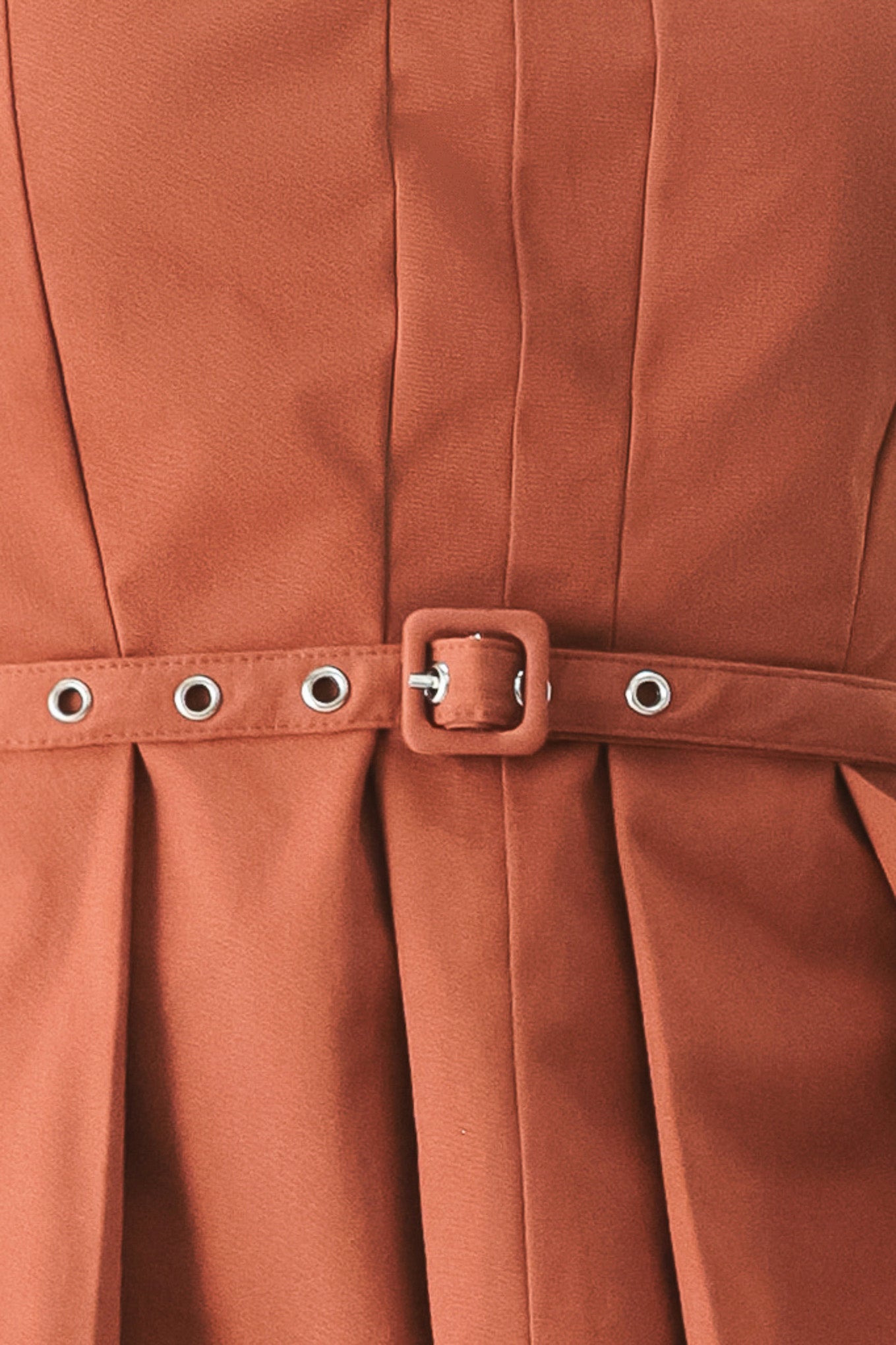 Close-up of a rust-colored top with belt with a buckle| Flying Tomato