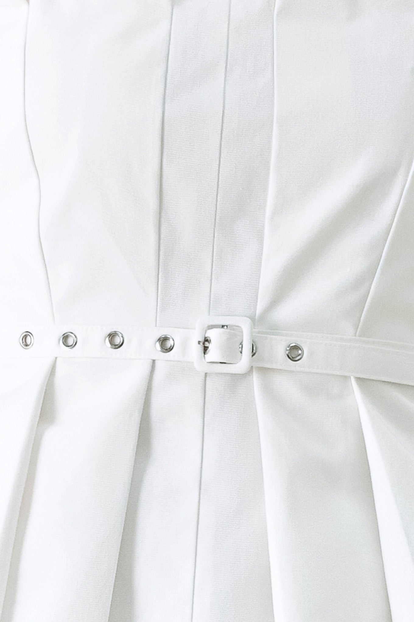 Woman wearing a white strapless top with a peplum waist and belt | Flying Tomato