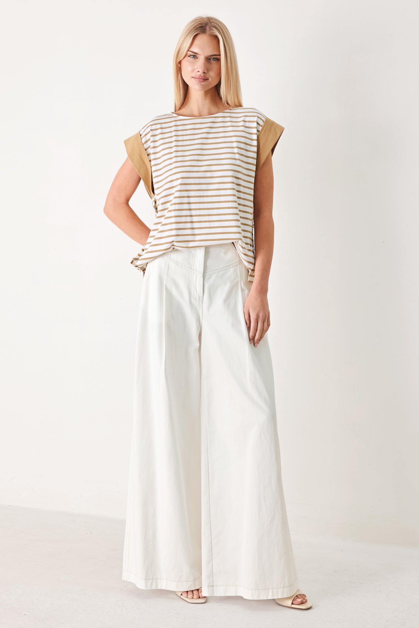Woman wearing a striped knit top with wide neckline, short sleeve and side button | FREEMARKET