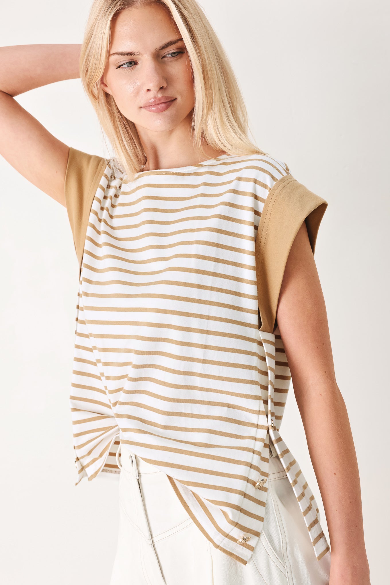 Woman wearing a striped knit top with wide neckline, short sleeve and side button | FREEMARKET