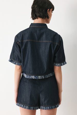 Woman wearing a dark denim crop jacket featuring short sleeve with fray edge and button down closure | FREEMARKET