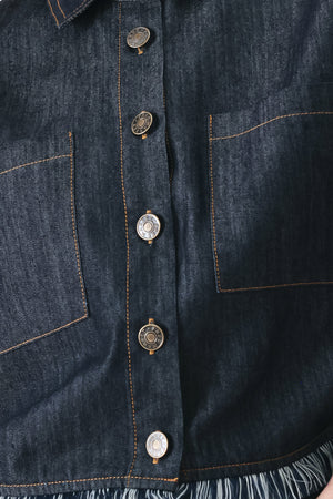 Close up of a dark denim crop jacket featuring short sleeve with fray edge and button down closure | FREEMARKET