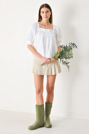 Woman wearing a white blouse featuring square neckline, elbow sleeve with cuff and back button closure | Flying Tomato
