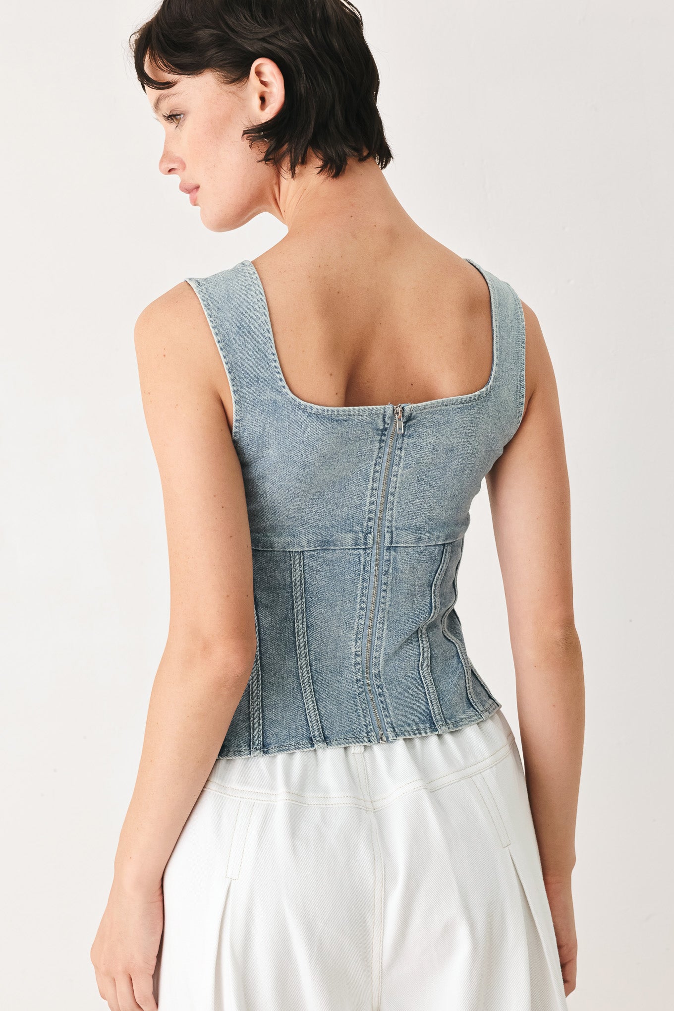 Woman wearing a denim corset denim top with square neckline and back zipper closure | FREEMARKET