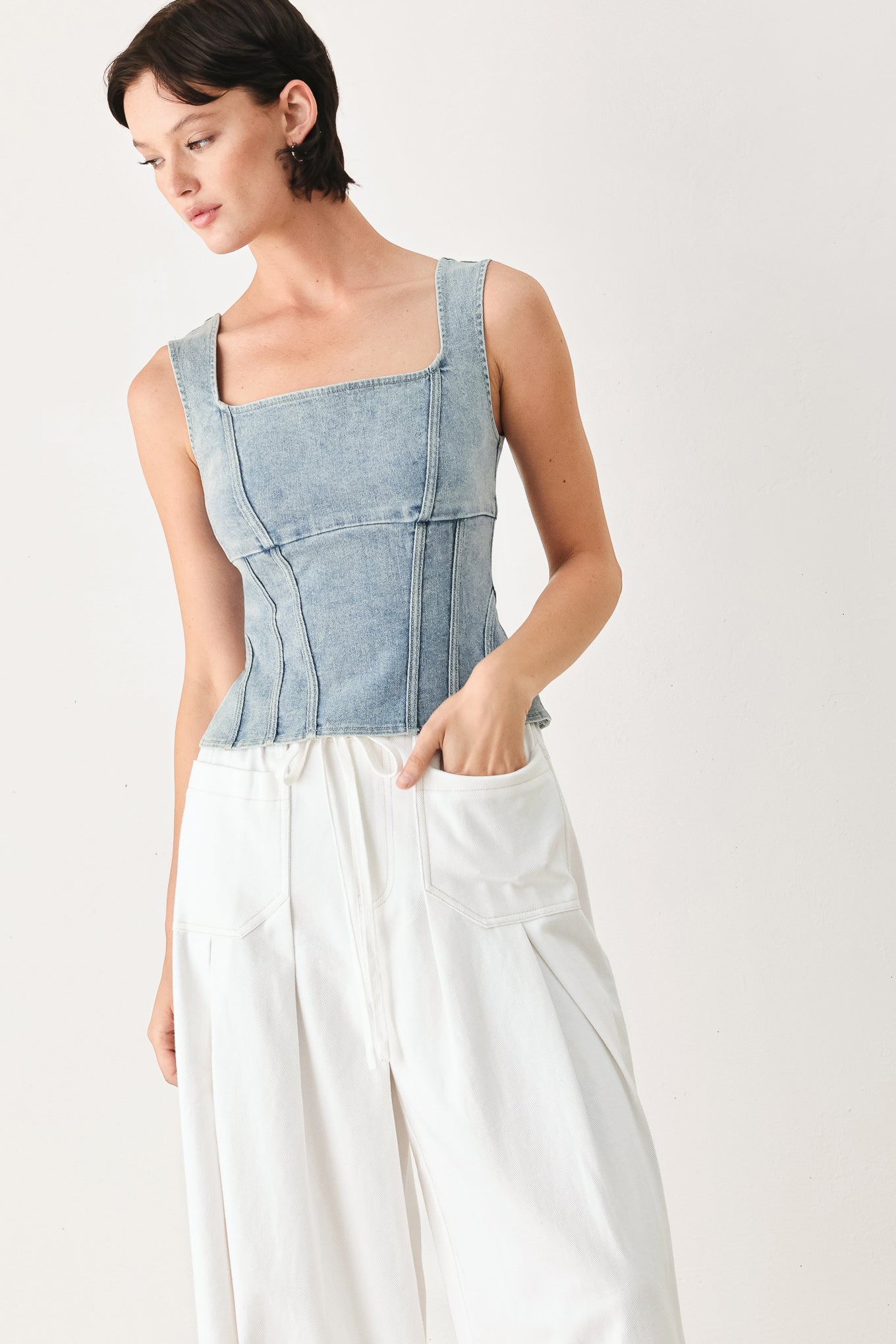 Woman wearing a denim corset denim top with square neckline and back zipper closure | FREEMARKET